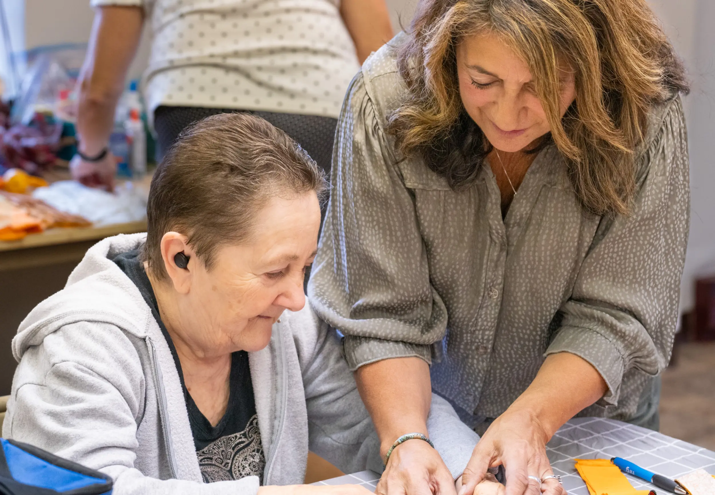 LBA staff member helping a client with an activity